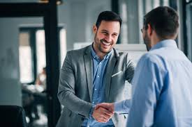 two businessmen shaking hands in a modern office, representing trust and partnership with the best digital marketing.