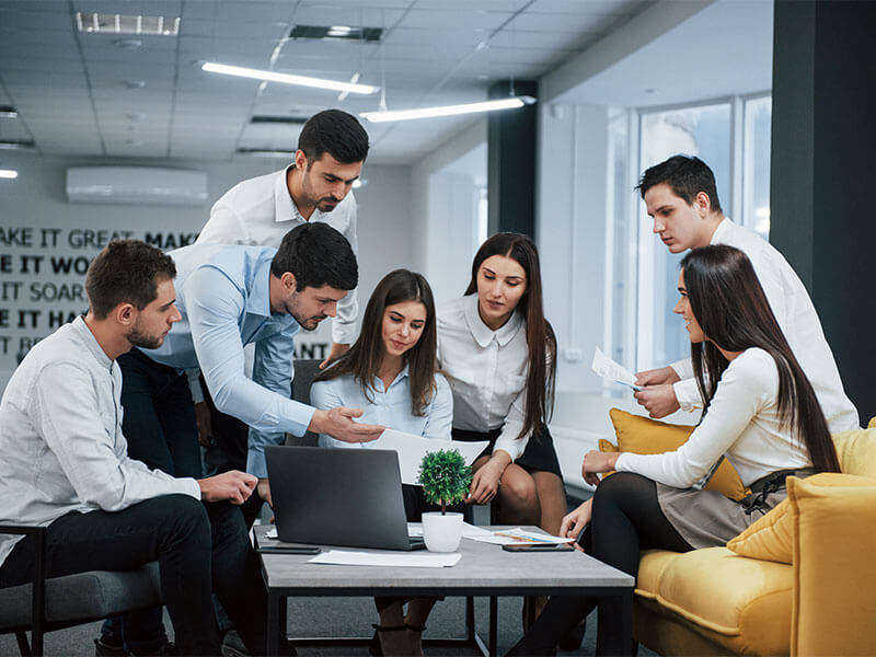A professional team of Website Designers In Surat collaborating on a project in a modern office.